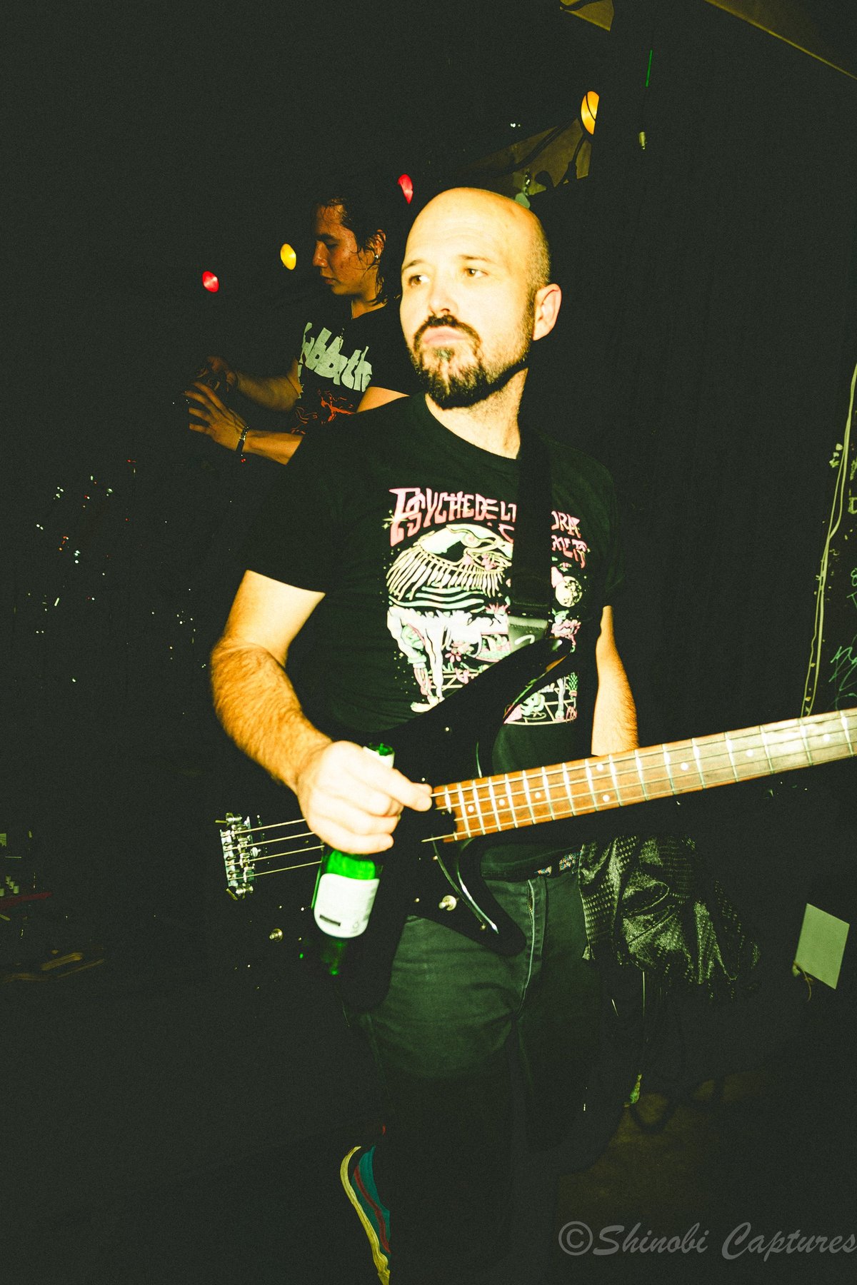 Bald bearded bass player performing during an Ozzy Osbourne tribute show
